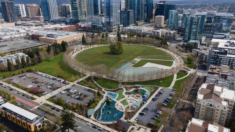 Aerial view of Bellevue Downtown Park, with lawns, paths, and the downtown skyline.