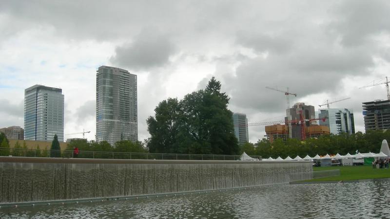 The circular lawn at Bellevue Downtown Park, with the downtown skyline beyond the water.