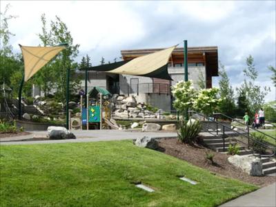 The back of the Lewis Creek Visitor Center, a wood building with a deck among the trees.