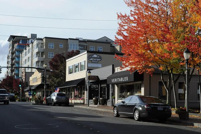 Old Main Street in Bellevue, with shops and a clock along the sidewalk.