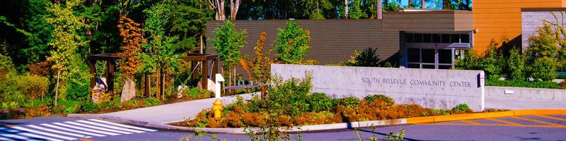 The main entrance of South Bellevue Community Center, with the building sign by the doors.