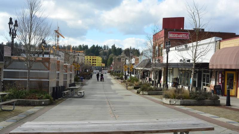 Pedestrian Main Street in Bothell, with brick buildings and a blue sky.