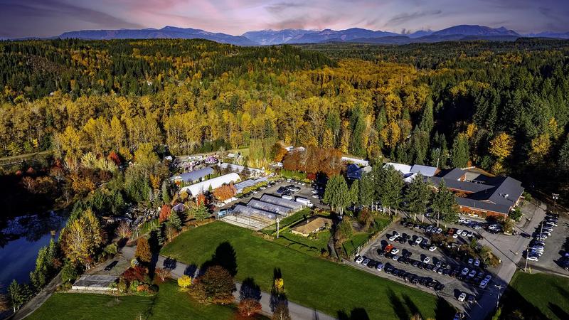 Remlinger Farms at sunset, with the farm grounds, rides, and the Snoqualmie Valley hills behind them.