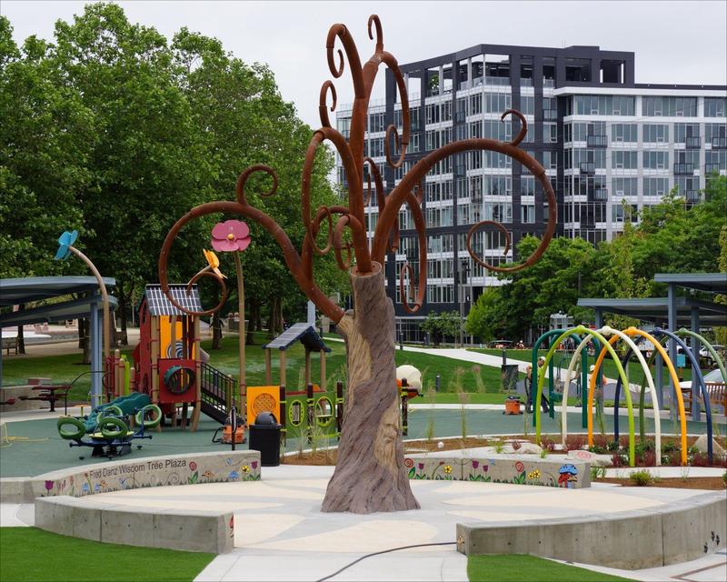 Play structure with slides and climbing nets at Inspiration Playground in Bellevue Downtown Park.