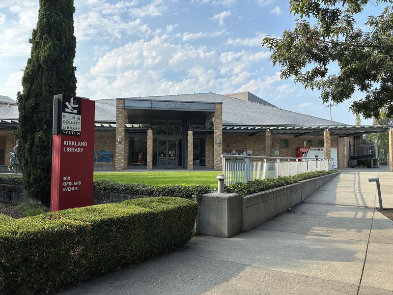 Kirkland Library entrance, with the library name over the glass doors.