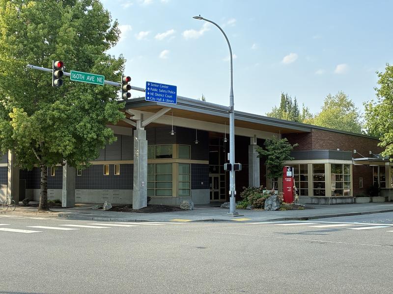 Redmond Library exterior, with a curved glass wall and the library sign.