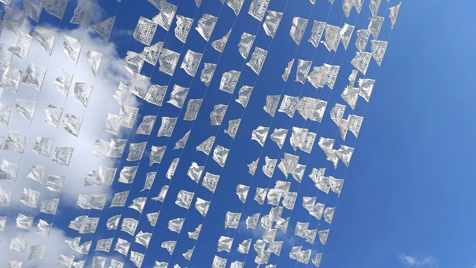 White papel picado banners hanging in a row.