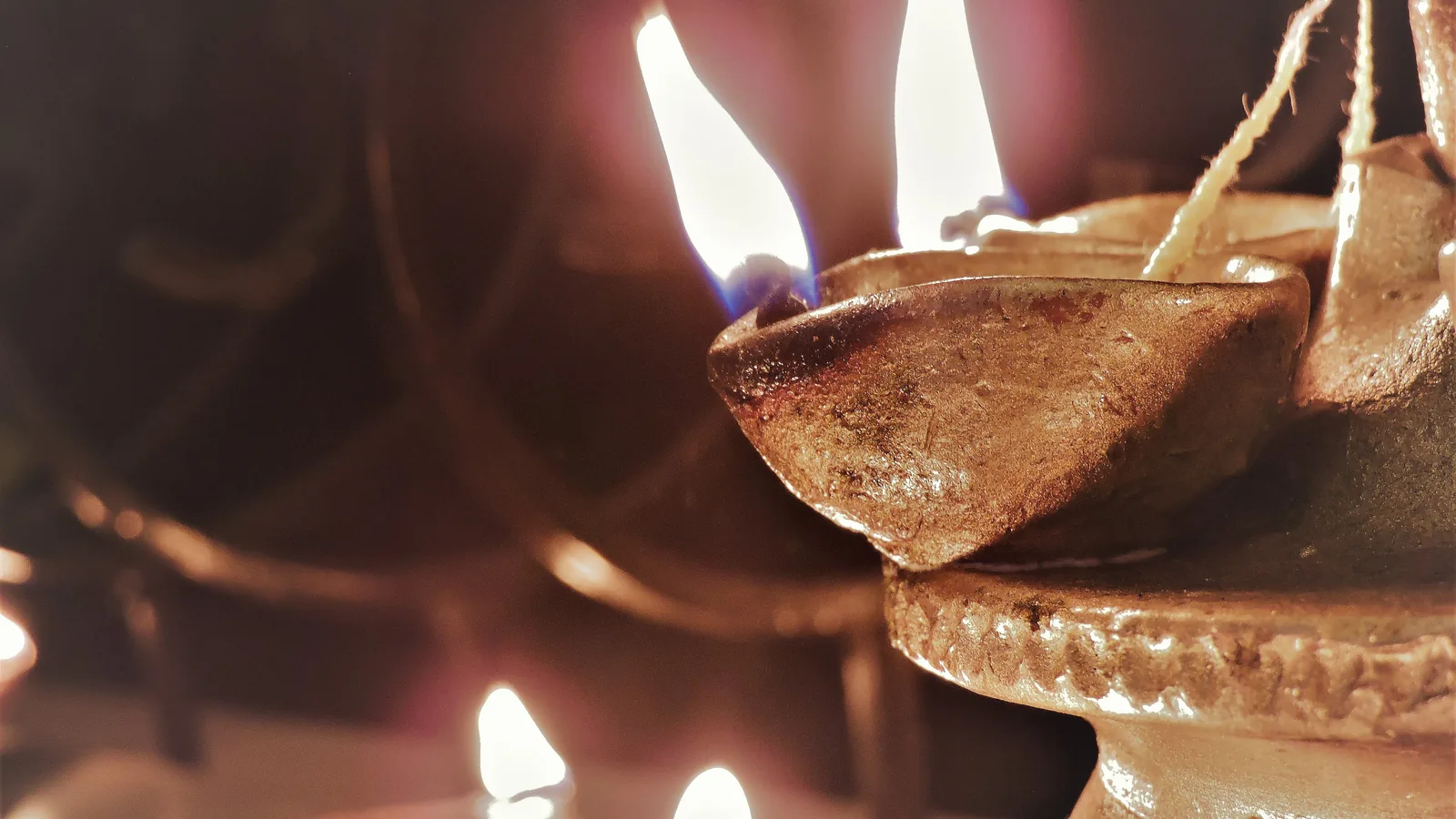 A lit clay oil lamp.