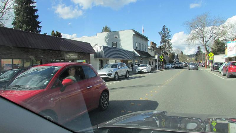 Front Street in Issaquah, with brick storefronts and the mountains behind the town.