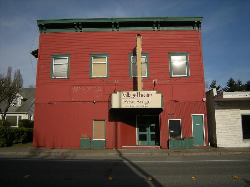Village Theatre in Issaquah, a brick building with a tower and a marquee over the entrance.