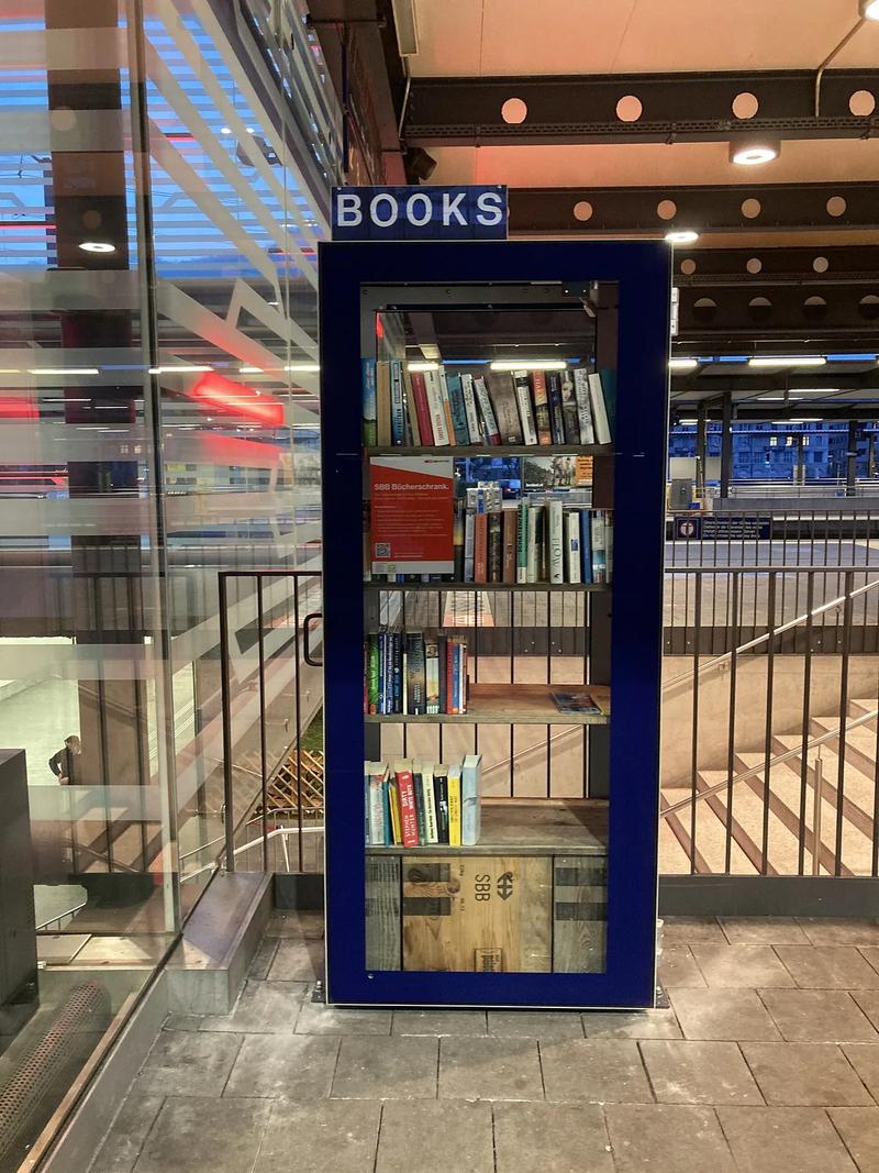 A wooden bookcase filled with books.