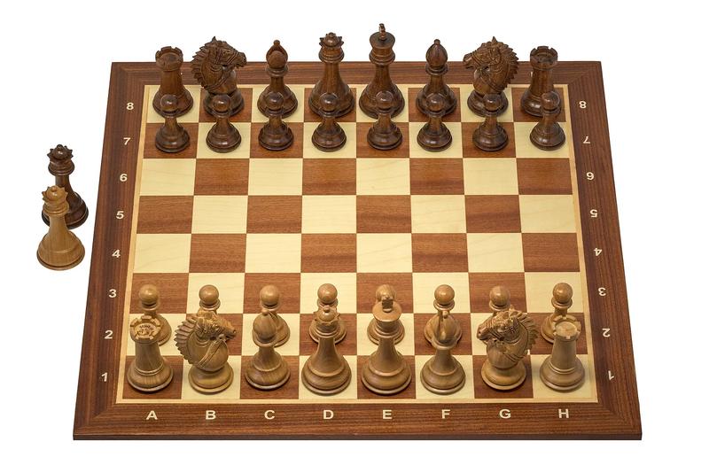 A Staunton chess set on a board, seen from the side.