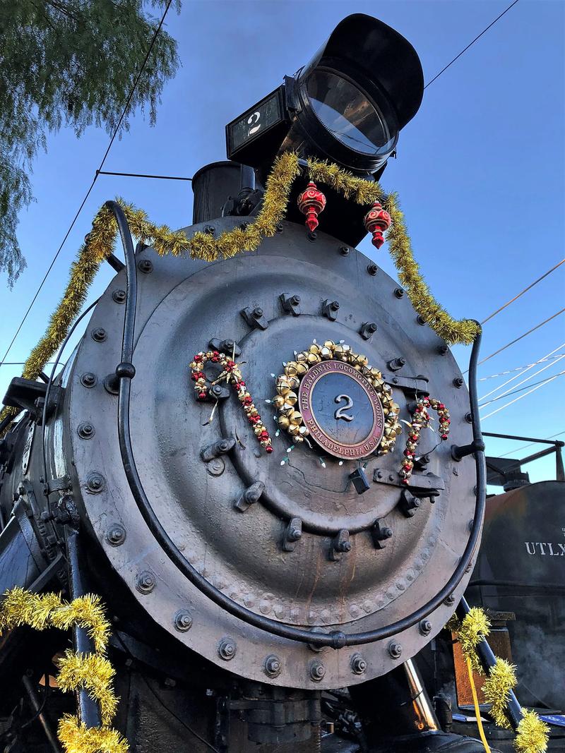 A small locomotive with a green wreath on the front.