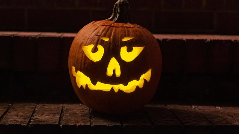 A carved jack-o-lantern glowing at night.