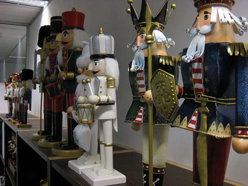 Wooden nutcracker figures lined up on a shelf.