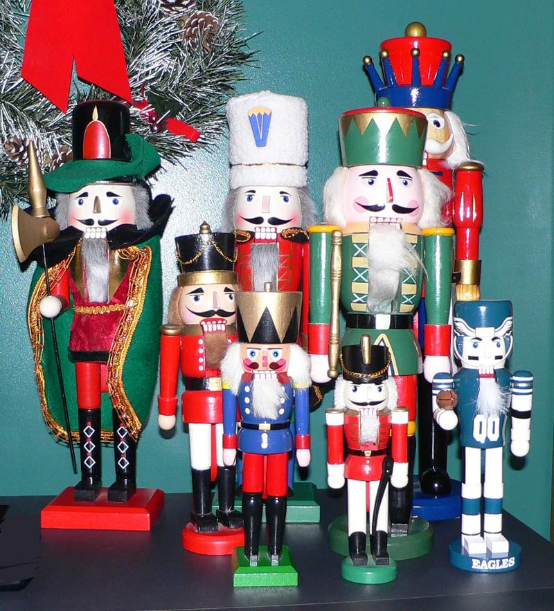 Three wooden nutcracker figures standing in a row.