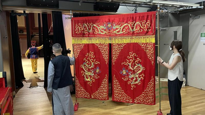 A red stage curtain in a theater.