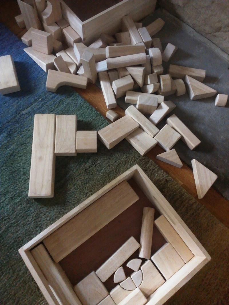 Two sets of plain wooden unit blocks.