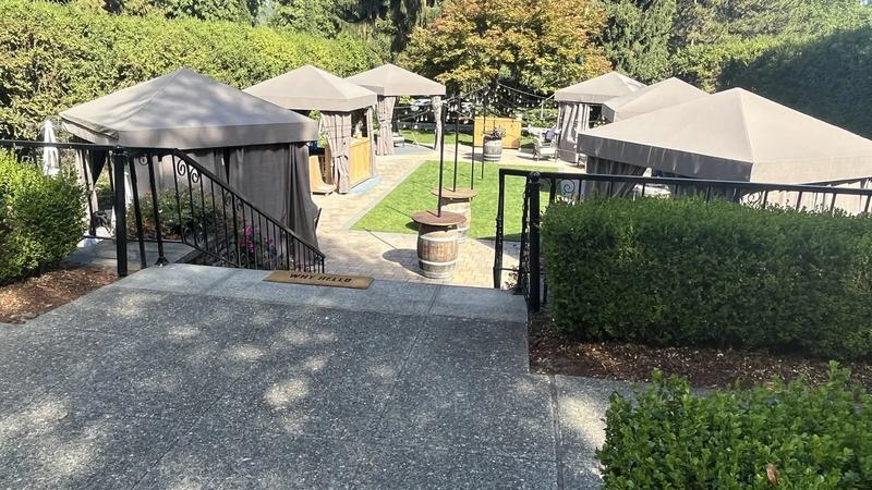 The chateau at Chateau Ste. Michelle in Woodinville, with lawn, a fountain, and blue sky.